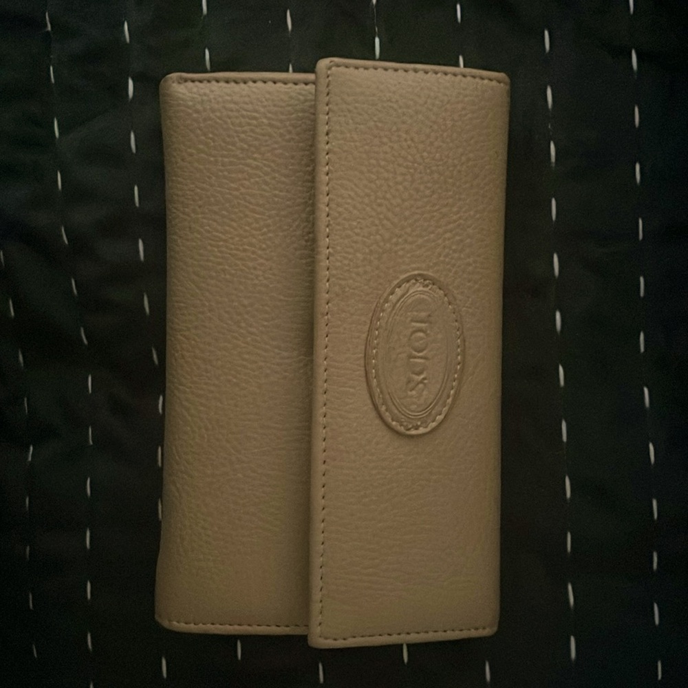 Tod’s tan wallet.  Used for 1 week.  No scratches or marks.